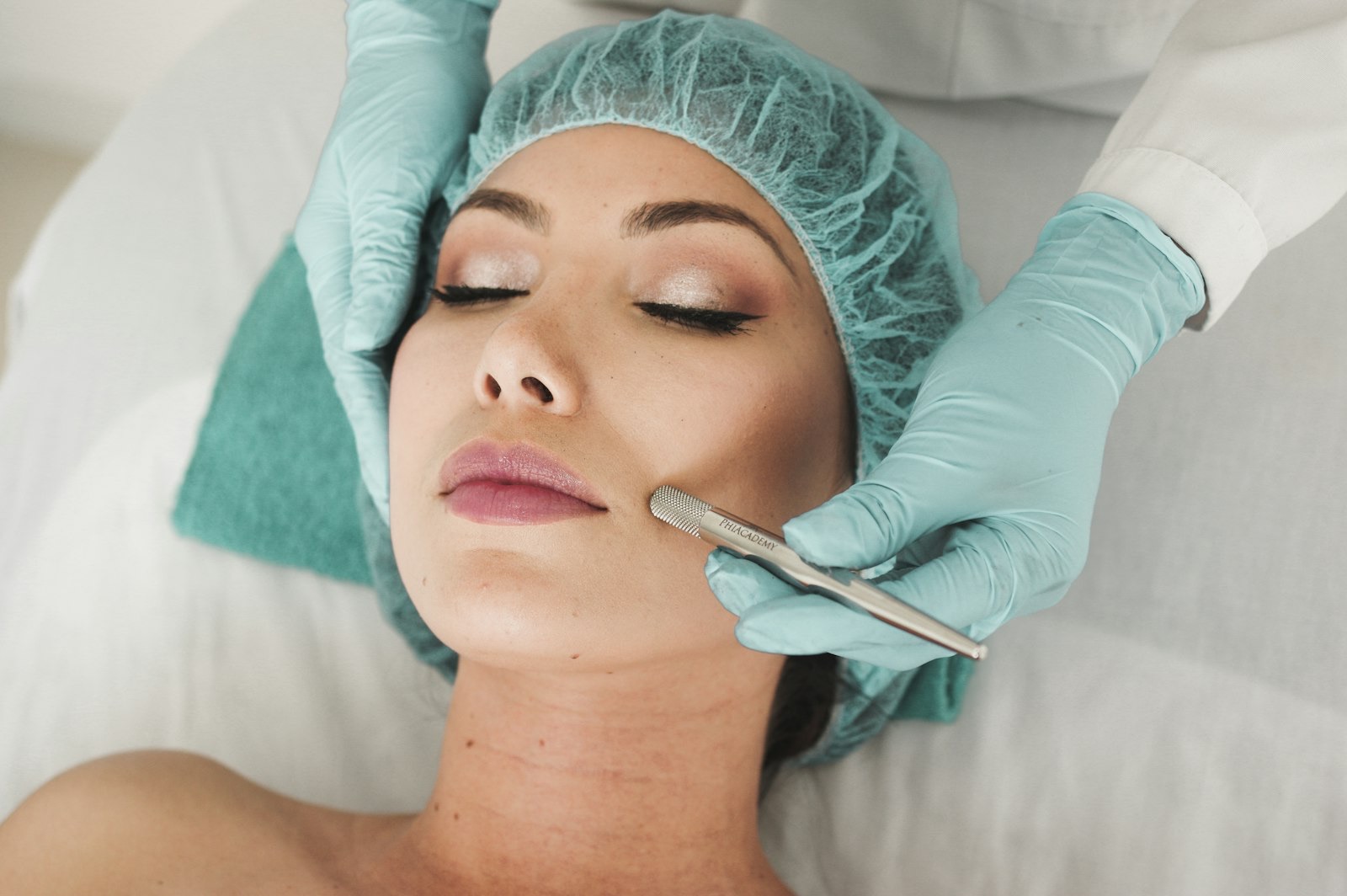 A practitioner performing a precise facial treatment with gloved hands